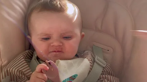 Babies complementary feeding from a spoon for the first time. infant's lunch wit Stock Footage 240558114