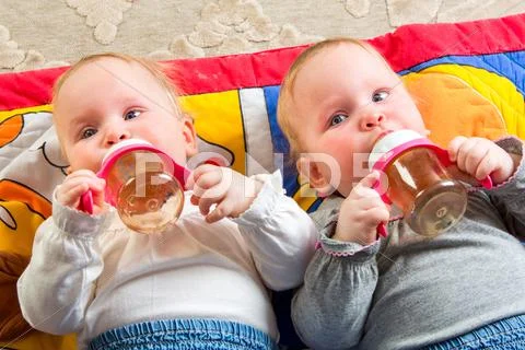 Babies eating from bottle Stock Photos