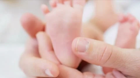 Babies feet proud parent Stock Footage