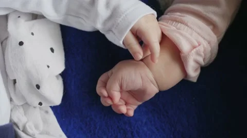 Babies' hands touch each other, two babies together Stock Footage 142902751