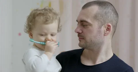 Baby 2 years old brushes his teeth with a toothbrush Stock Footage 233982909