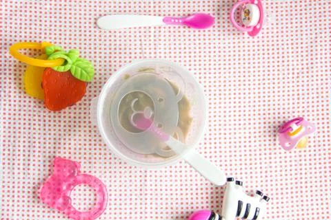 Baby accessories on pink pattern background on table Stock Photos