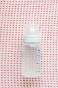 Baby accessories on pink pattern background on table Stock Photos