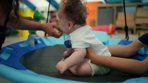 Baby with adult support developing motor skills during early intervention and 스톡 동영상 342871673