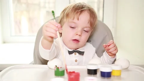 Baby and Easter egg paint Stock Footage 149846973