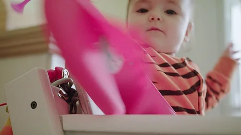 Baby is angry at a plastic spoon Stock Footage 83611778