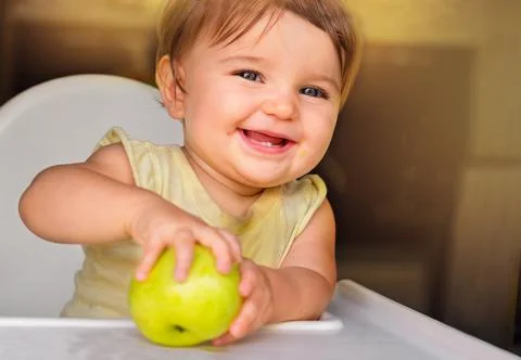 Baby with an apple. Stock Photos