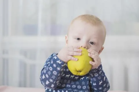 Baby with an apple Stock Photos