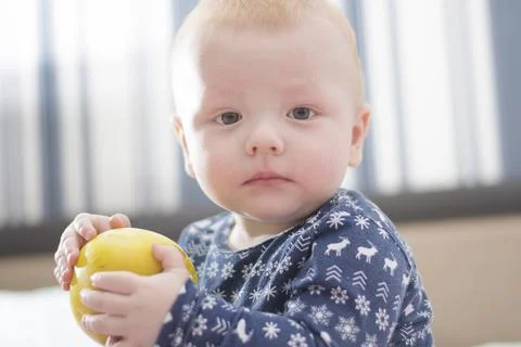 Baby with an apple Stock Photos