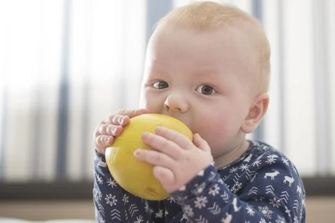 Baby with an apple Stock Photos