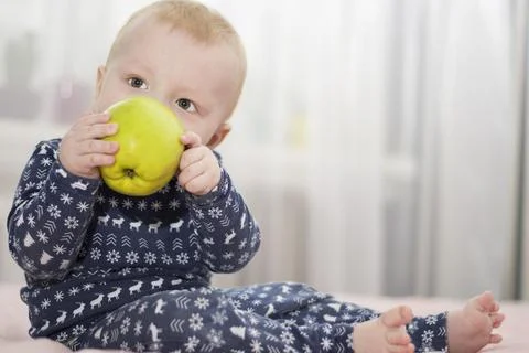 Baby with an apple Stock Photos