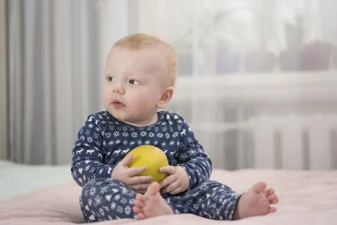 Baby with an apple Stock Photos