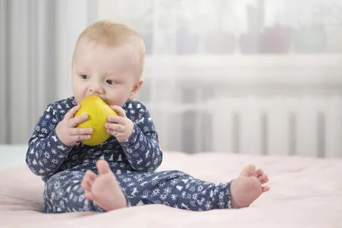 Baby with an apple Stock Photos