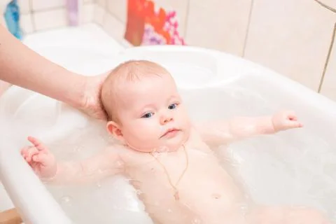 Baby bathing in the bath Stock Photos