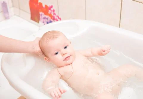 Baby bathing in the bath Stock Photos
