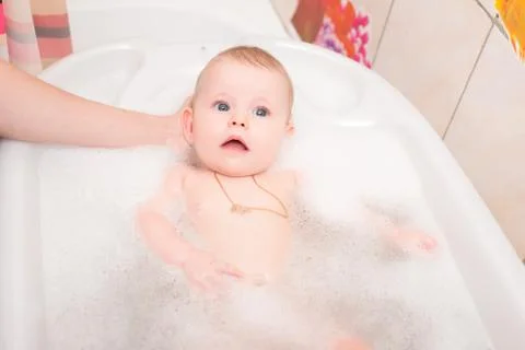 Baby bathing in the bath Stock Photos