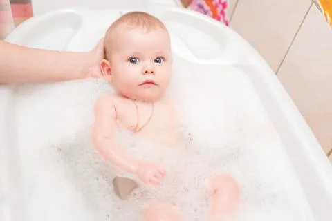 Baby bathing in the bath Stock Photos
