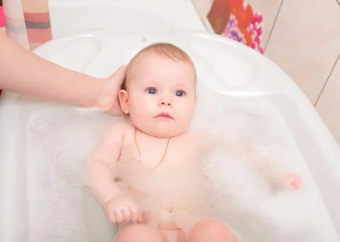 Baby bathing in the bath Stock Photos