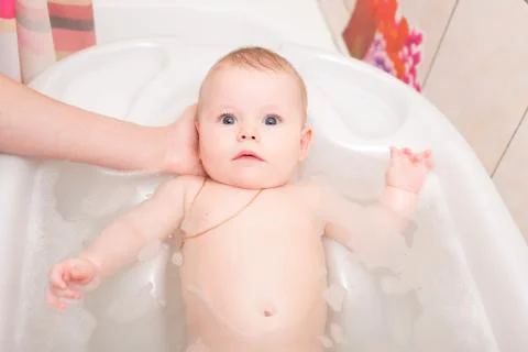 Baby bathing in the bath Stock Photos