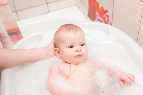 Baby bathing in the bath Stock Photos