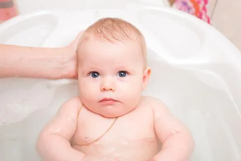 Baby bathing in the bath Stock Photos