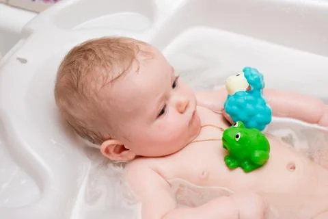 Baby bathing in the bath Stock Photos