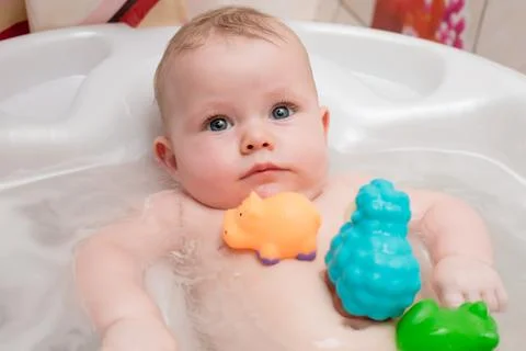 Baby bathing in the bath Stock Photos