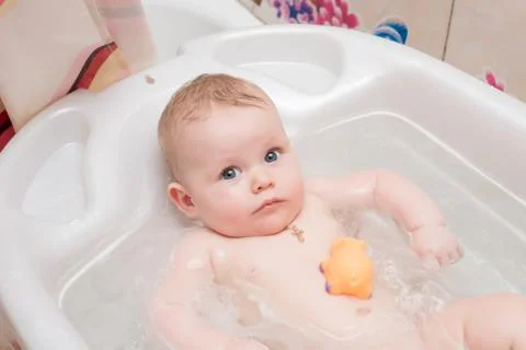 Baby bathing in the bath Stock Photos