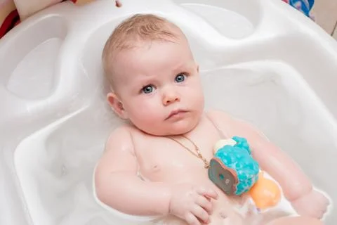 Baby bathing in the bath Stock Photos