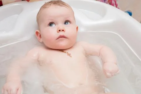 Baby bathing in the bath Stock Photos