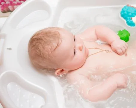 Baby bathing in the bath Stock Photos
