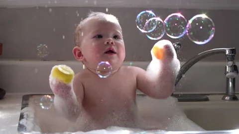 Baby bathing in the sink in bubbles Stock Footage 221514355