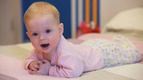 Baby on a bed in the bedroom Stock Footage