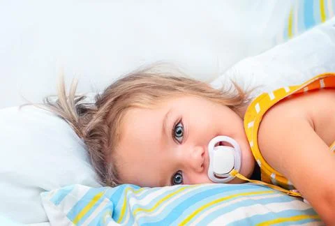 Baby on the bed smiling Stock Photos