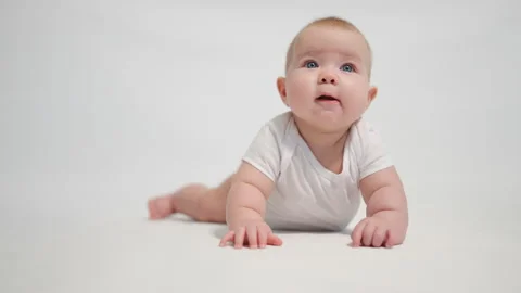 The baby begins to try to crawl. one of the stages of development of the chil Stock-Footage 233164562