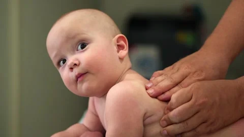 A baby is being massaged by a person 스톡 동영상 319511853
