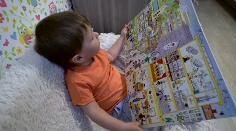 Baby with a big book2 Stock Footage 62951898