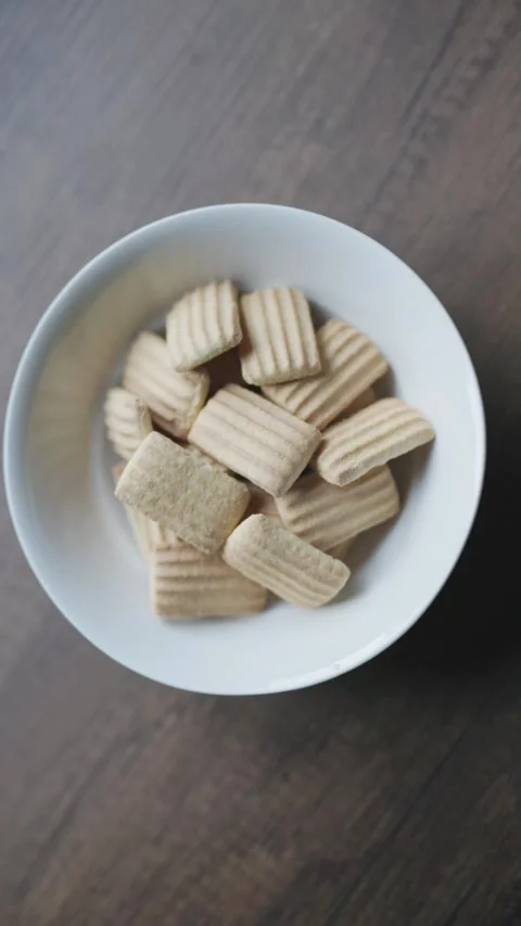 Baby biscuits served in a clean white bowl Stock Footage 342024770