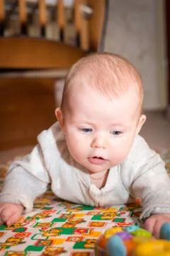 Baby with blue eyes crawling Stock Photos