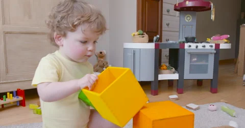 Baby boy building tower of square blocks slow motion 60fps 1 Video stock 57651633