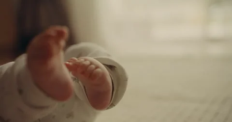 Baby Boy Close-Up Playing with Tiny Feet Stock Footage 318687197