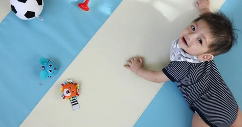 Baby boy crawl playing on soft mattress floor in nursery room Stock Footage 85993526