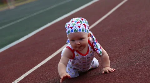 Baby boy crawling in the stadium Stock Footage 40754747