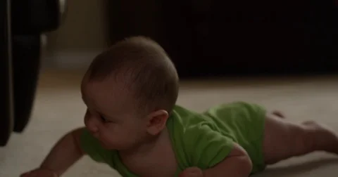 Baby boy crawls on ground Stock Footage