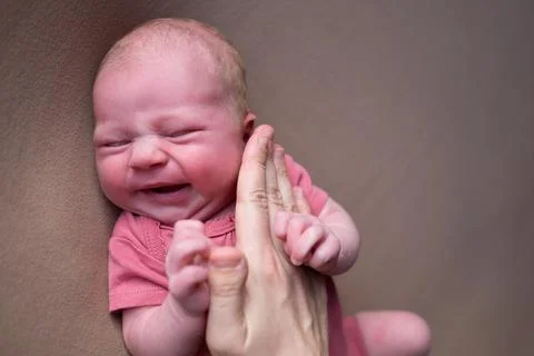 Baby boy crying while posing for his first portrait Stock Photos