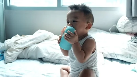 Baby boy enjoying bite rubber toy in cozy room Stock Footage 113170772