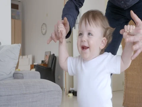 Baby boy first steps with a helping hand Slow motion Stock-Footage 72252577