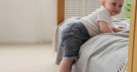 Baby boy getting down from bed Video stock 156520247