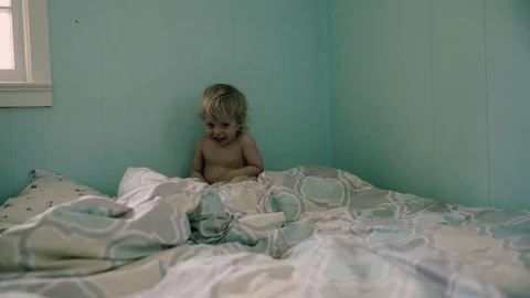 Baby boy is jumping in the bed Stock-Footage 74679627
