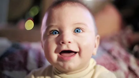 Baby boy little happy. Smiling, looking up. Glad. Blue eyes. Funny. Looking Stock Footage